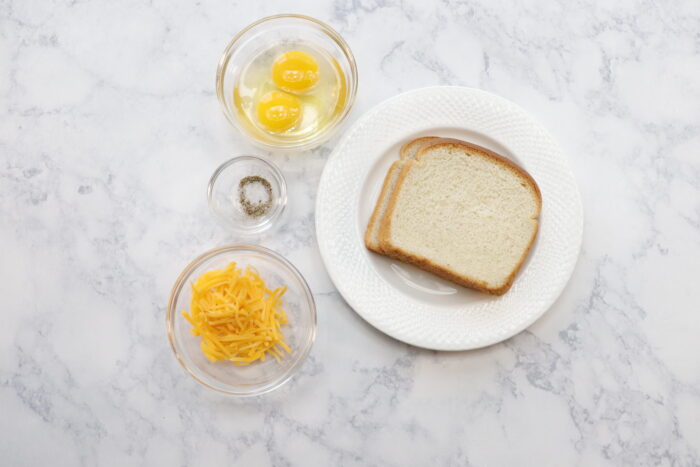 Ingredients for air fryer eggs in a baske