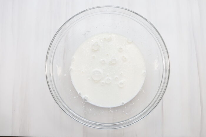 Cream cheese and milk in glass bowl before mixing