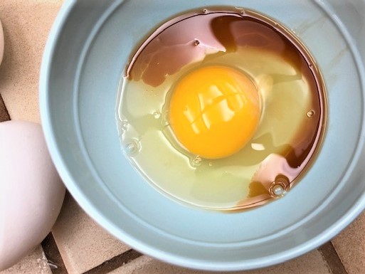 Eggs and vanilla extract in a bowl for chocolate chip cookies