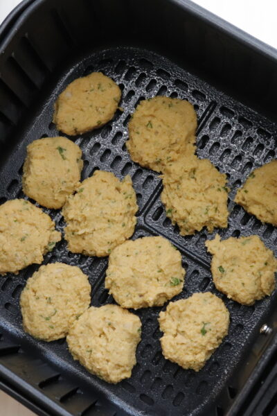 air fryer falafel patties uncooked in air fryer basket