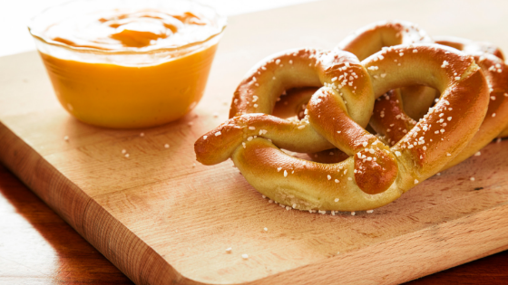 beer cheese dip next to pretzels