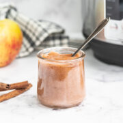 Instant pot applesauce in a glass jar with spoon