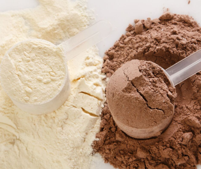 chocolate and vanilla protein powder with scoops