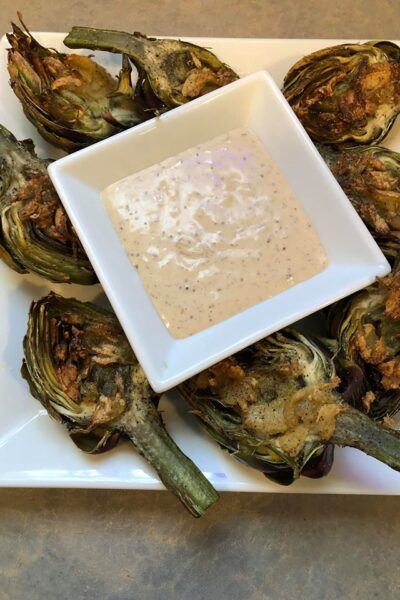 roasted artichokes with remoulade on white plate | Slap Dash Mom