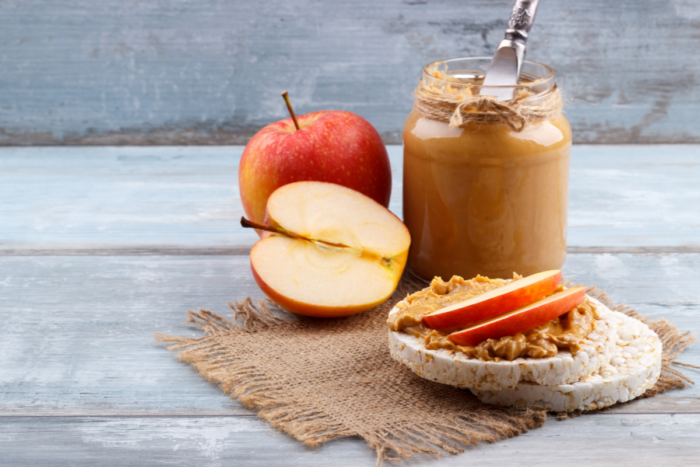 rice cake with peanut butter topped with apple slices