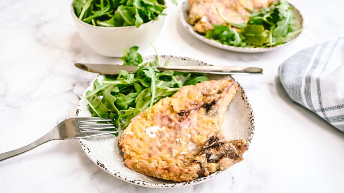 air fryer pork chops with fork and salad