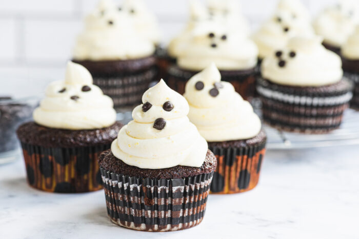 front view of ghost cupcakes with chocolate chips for eyes