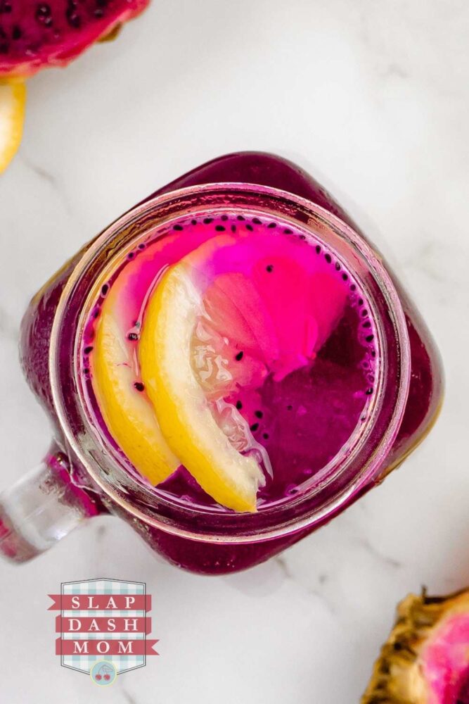 top shot of dragon fruit lemonade with lemons in the glass